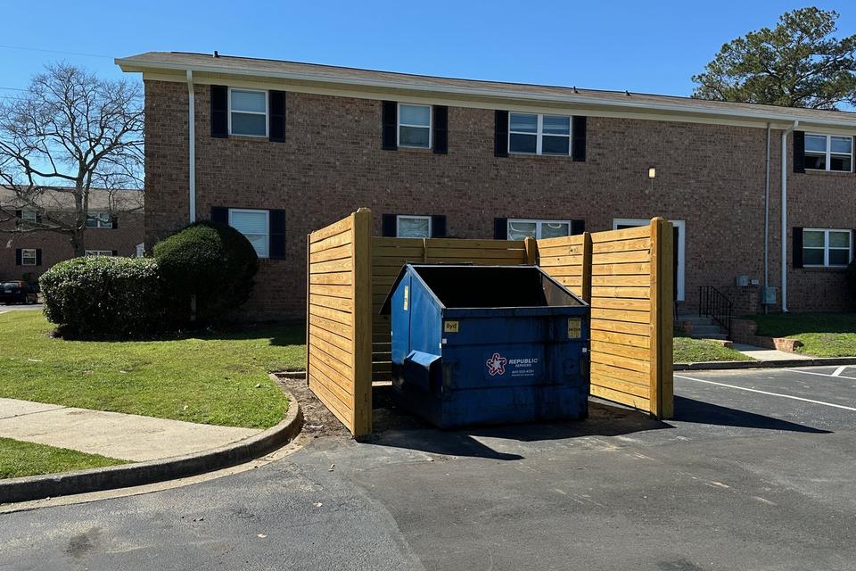 The same dumpster corral cleared, with nothing left beside it